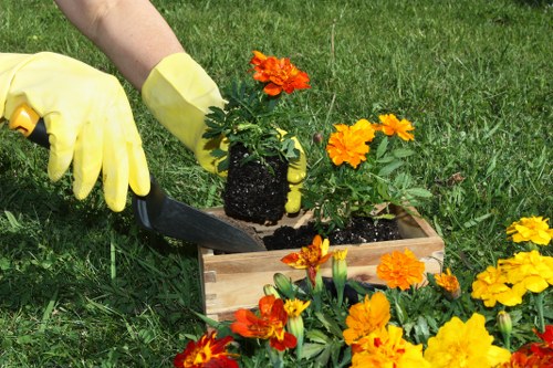Gardener using PPE while carrying out garden maintenance